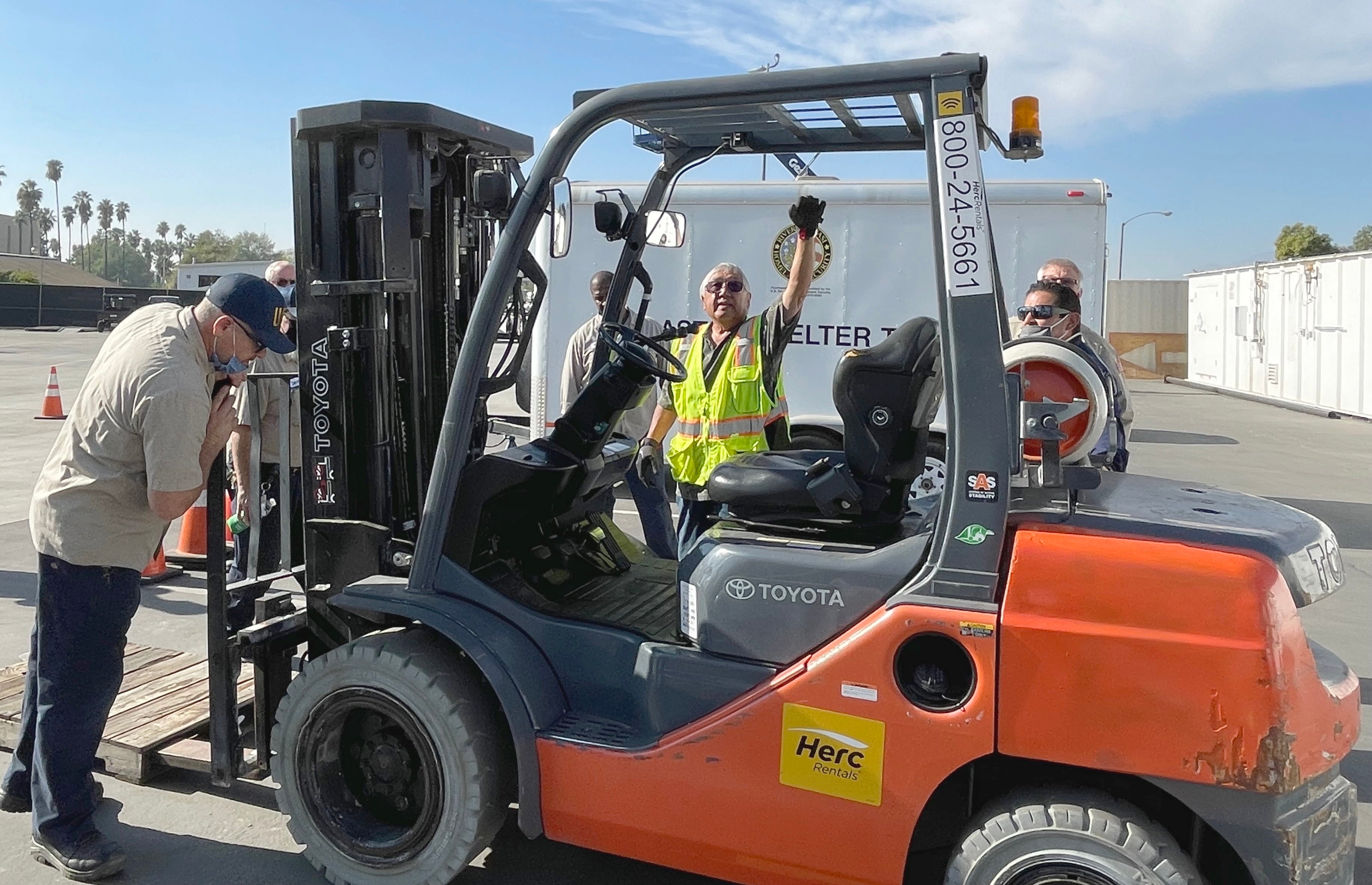 Instructor pointing to parts of a forklift for hands-on training