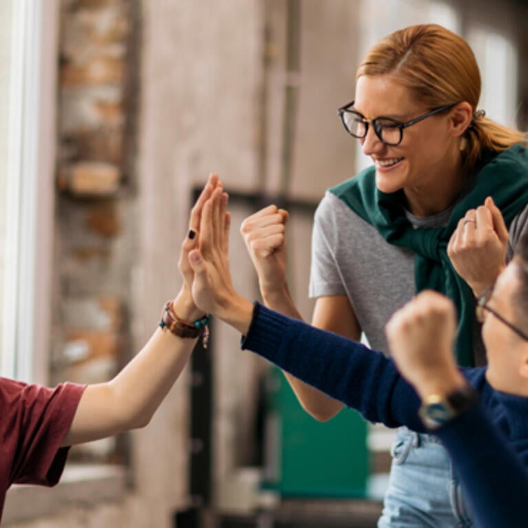 Colleagues giving high fives