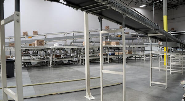 Conveyor belts moving paper products in a factory