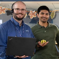 An employee with a laptop and headset