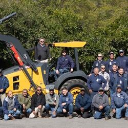 Landscape team around a large tractor