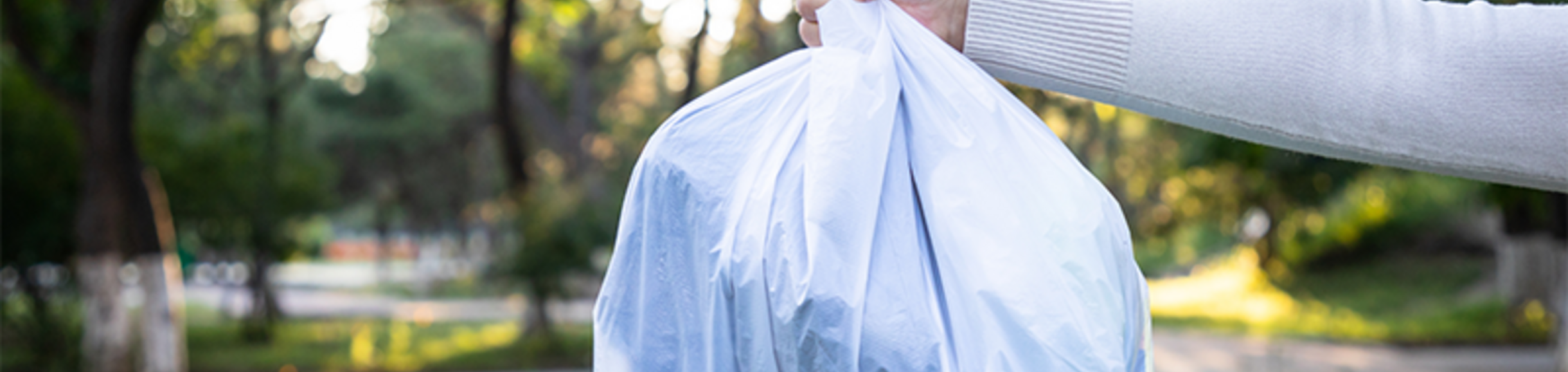 Hand holding a trash bag