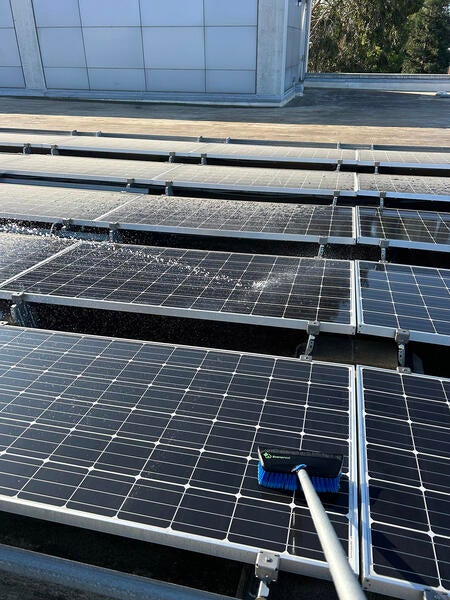 Handle brush cleaning solar panels