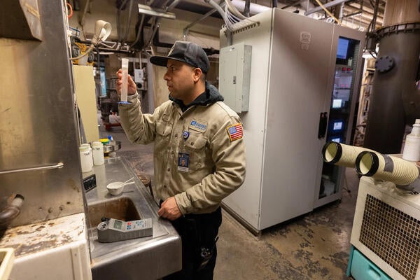 Plant operator reading a water test in a plant control room