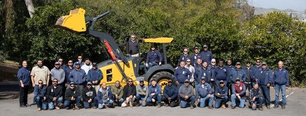 Landscape team around a large tractor