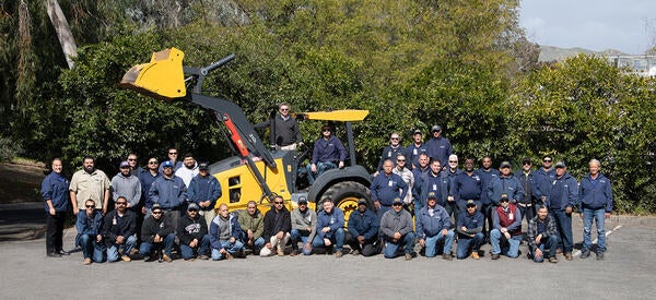 Landscape team around a large tractor