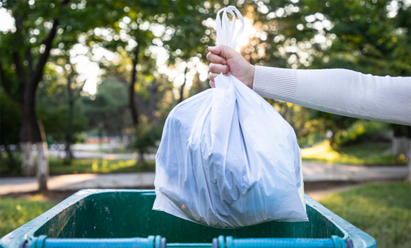 Hand holding a trash bag