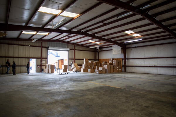 Boxes are delivered in an empty warehouse