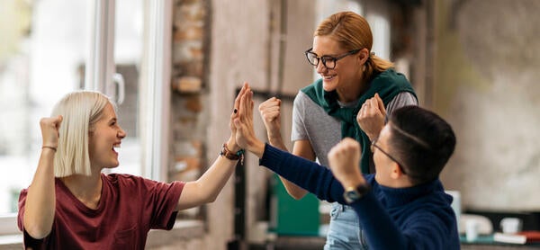 Colleagues giving high fives