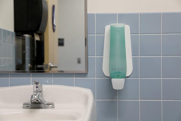 Soap dispenser next to a sink